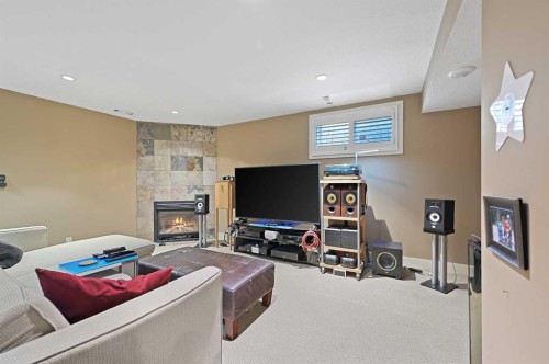 41 Strathridge Crescent Sw, Calgary, AB - Indoor Photo Showing Basement With Fireplace