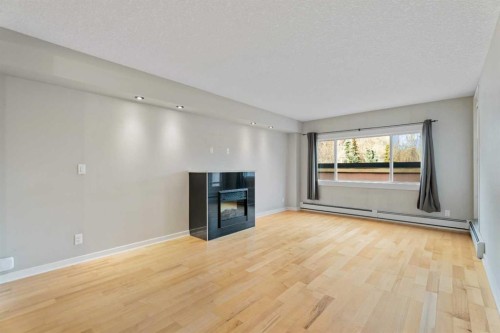 404-728 3 Avenue Nw, Calgary, AB - Indoor Photo Showing Living Room With Fireplace