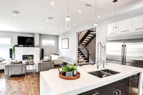 411 9 Street Ne, Calgary, AB - Indoor Photo Showing Kitchen With Fireplace With Double Sink With Upgraded Kitchen