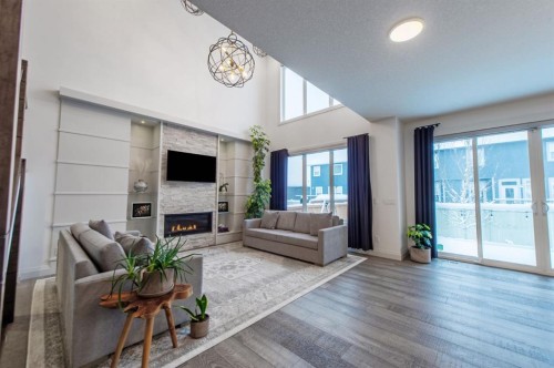 214 Aspenmere Green, Chestermere, AB - Indoor Photo Showing Living Room With Fireplace
