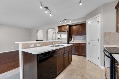 161 Silverado Range Cove Sw, Calgary, AB - Indoor Photo Showing Kitchen With Double Sink