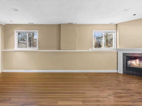 107 Woodford Crescent Sw, Calgary, AB - Indoor With Fireplace