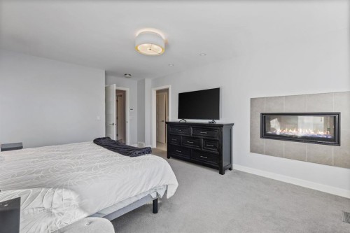 2419 22 Street Nw, Calgary, AB - Indoor Photo Showing Bedroom With Fireplace