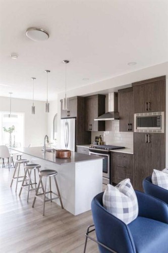 25 Sunrise Way, Cochrane, AB - Indoor Photo Showing Kitchen With Upgraded Kitchen