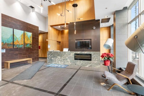 303-550 Riverfront Avenue Se, Calgary, AB - Indoor Photo Showing Other Room With Fireplace