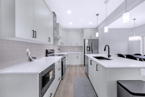 154 Silver Spruce Grove Sw, Calgary, AB - Indoor Photo Showing Kitchen With Stainless Steel Kitchen With Double Sink With Upgraded Kitchen
