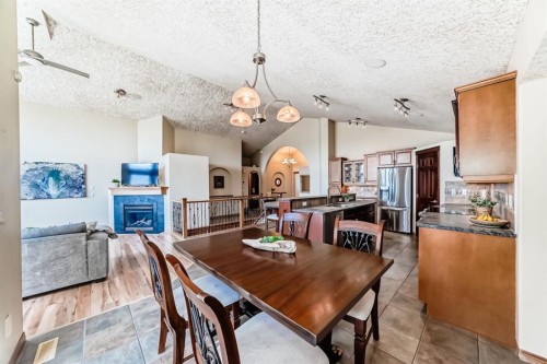 150 Hidden Creek Heights Nw, Calgary, AB - Indoor Photo Showing Dining Room With Fireplace