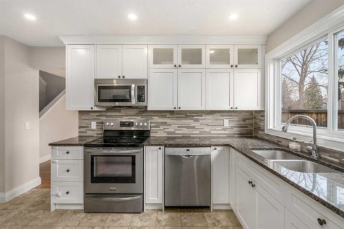 14-2815 Palliser Drive Sw, Calgary, AB - Indoor Photo Showing Kitchen With Double Sink