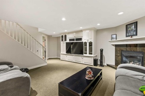 25 Mckinley Bay Se, Calgary, AB - Indoor With Fireplace