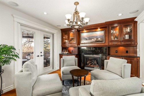 25 Mckinley Bay Se, Calgary, AB - Indoor Photo Showing Living Room With Fireplace