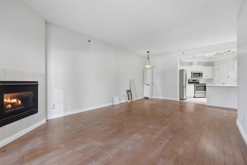 402-820 15 Avenue Sw, Calgary, AB - Indoor Photo Showing Living Room With Fireplace