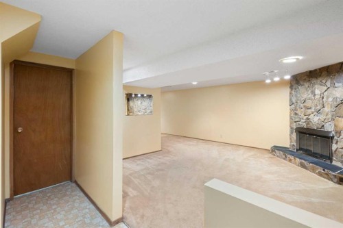123 Glacier Drive Sw, Calgary, AB - Indoor Photo Showing Other Room With Fireplace