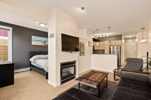 311-208 Holy Cross Lane Sw, Calgary, AB - Indoor Photo Showing Living Room With Fireplace