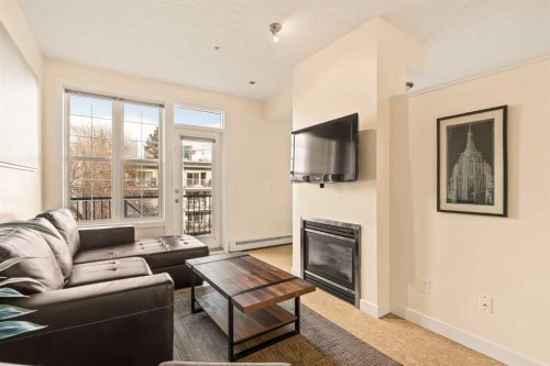 311-208 Holy Cross Lane Sw, Calgary, AB - Indoor Photo Showing Living Room With Fireplace