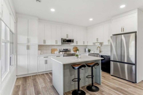 50 Riviera View, Cochrane, AB - Indoor Photo Showing Kitchen With Stainless Steel Kitchen With Upgraded Kitchen