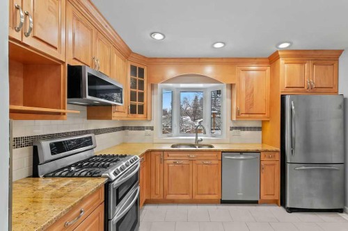 6407 Lombardy Crescent Sw, Calgary, AB - Indoor Photo Showing Kitchen With Double Sink