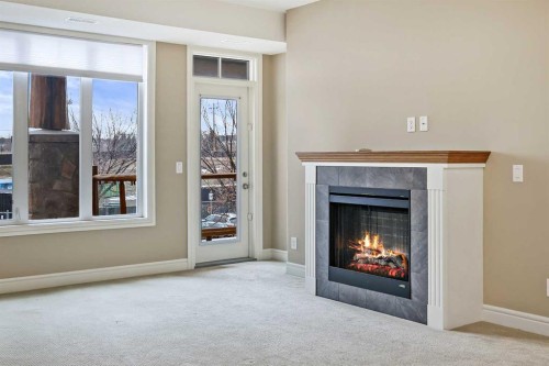 1243-2330 Fish Creek Boulevard Sw, Calgary, AB - Indoor Photo Showing Living Room With Fireplace