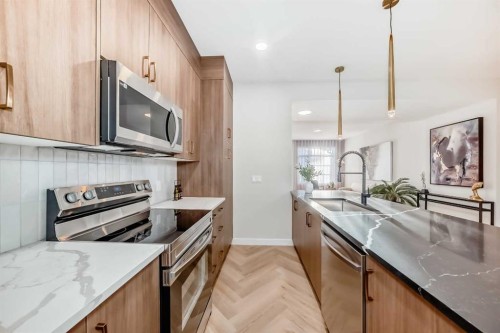 409 Clydesdale Avenue, Cochrane, AB - Indoor Photo Showing Kitchen With Upgraded Kitchen