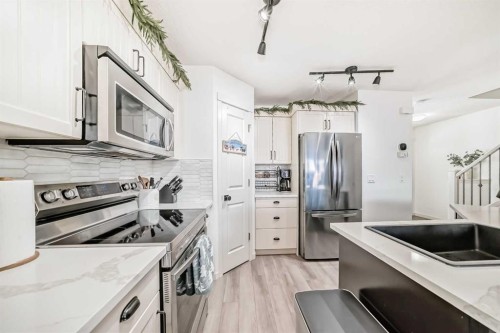 14 Autumn Crescent Se, Calgary, AB - Indoor Photo Showing Kitchen With Stainless Steel Kitchen With Double Sink With Upgraded Kitchen