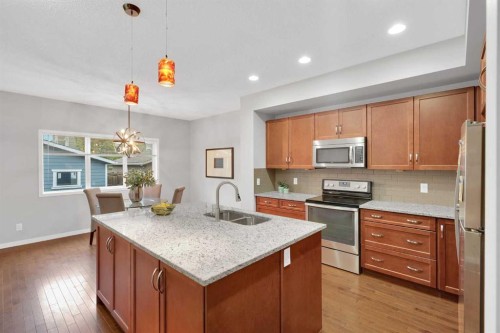 195 Marquis Common Se, Calgary, AB - Indoor Photo Showing Kitchen With Stainless Steel Kitchen With Double Sink