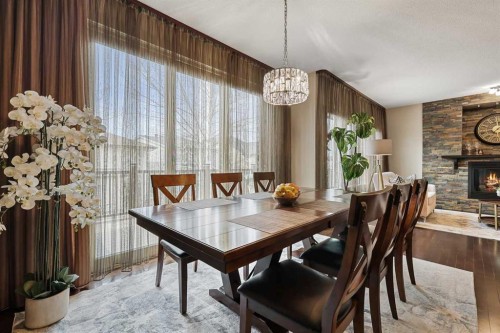 20 Walden View Se, Calgary, AB - Indoor Photo Showing Dining Room With Fireplace