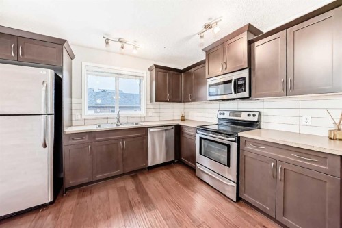 16 Fireside Way, Cochrane, AB - Indoor Photo Showing Kitchen With Double Sink