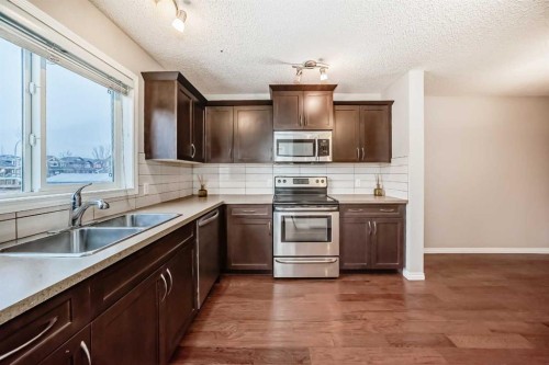 16 Fireside Way, Cochrane, AB - Indoor Photo Showing Kitchen With Double Sink