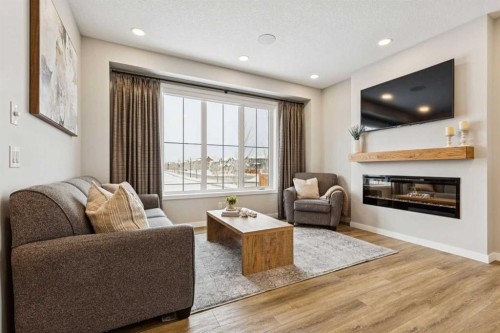 103 Saddlebred Link, Cochrane, AB - Indoor Photo Showing Living Room With Fireplace