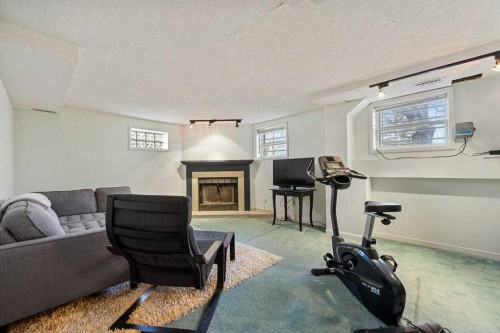 3204 24A Street Sw, Calgary, AB - Indoor Photo Showing Gym Room With Fireplace