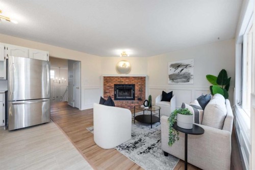 47 Hawkstone Drive Nw, Calgary, AB - Indoor Photo Showing Living Room With Fireplace