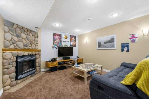 178 Cranwell Close Se, Calgary, AB - Indoor Photo Showing Living Room With Fireplace