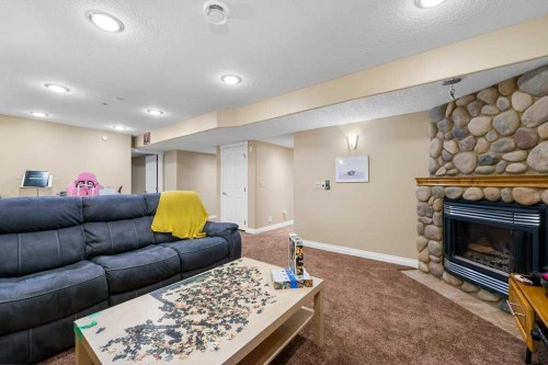 178 Cranwell Close Se, Calgary, AB - Indoor Photo Showing Living Room With Fireplace