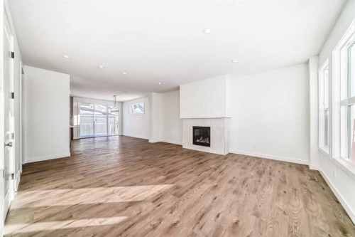 191 Perch Bend, Rural Rocky View County, AB - Indoor With Fireplace