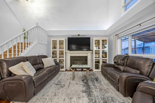 60 Tuscarora Way Nw, Calgary, AB - Indoor Photo Showing Living Room With Fireplace