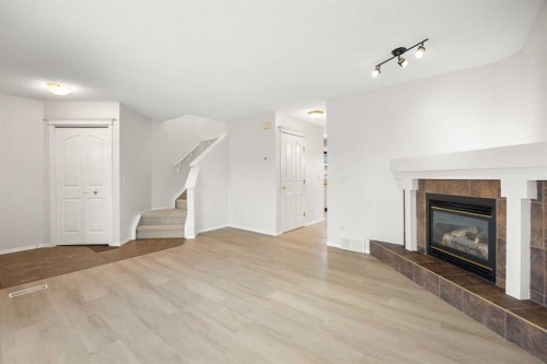 13 Coville Gardens Ne, Calgary, AB - Indoor Photo Showing Other Room With Fireplace