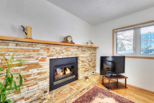 104 Dalgleish Bay Nw, Calgary, AB - Indoor Photo Showing Living Room With Fireplace