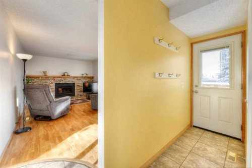 104 Dalgleish Bay Nw, Calgary, AB - Indoor Photo Showing Other Room With Fireplace