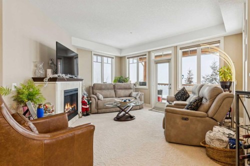 2308-2330 Fish Creek Boulevard Sw, Calgary, AB - Indoor Photo Showing Living Room With Fireplace