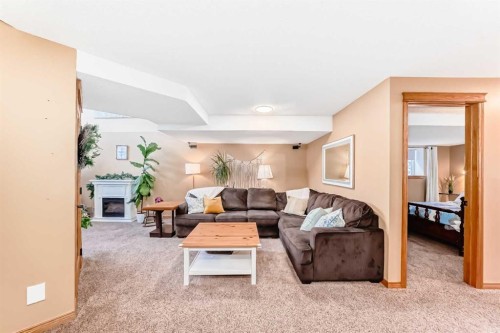 203 Hidden Spring Green Nw, Calgary, AB - Indoor Photo Showing Other Room With Fireplace
