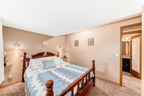 203 Hidden Spring Green Nw, Calgary, AB - Indoor Photo Showing Bedroom