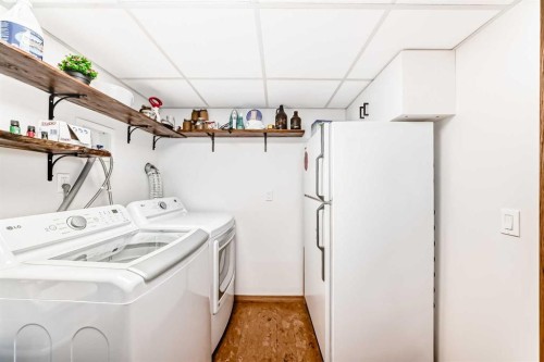 203 Hidden Spring Green Nw, Calgary, AB - Indoor Photo Showing Laundry Room