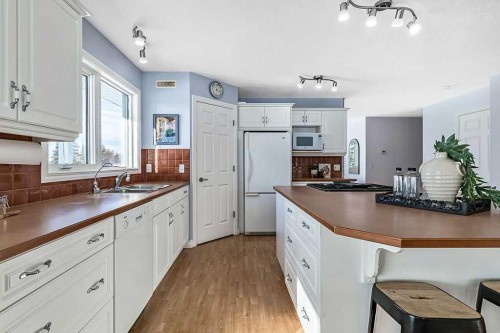 180 16Th Avenue Sw, Diamond Valley, AB - Indoor Photo Showing Kitchen With Double Sink