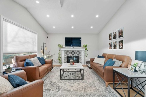 117 Rocky Ridge Landing Nw, Calgary, AB - Indoor Photo Showing Living Room With Fireplace