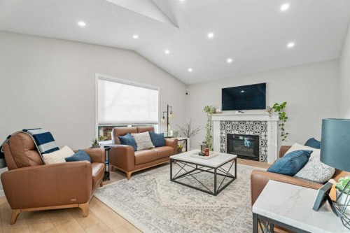 117 Rocky Ridge Landing Nw, Calgary, AB - Indoor Photo Showing Living Room With Fireplace