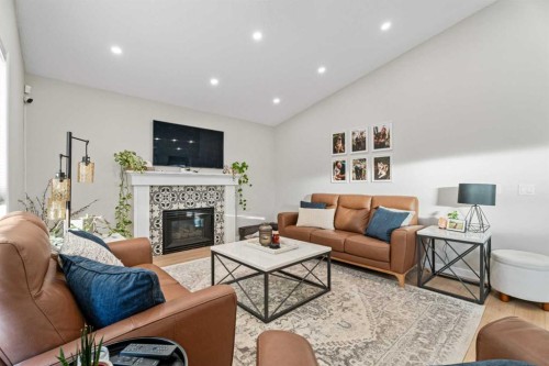 117 Rocky Ridge Landing Nw, Calgary, AB - Indoor Photo Showing Living Room With Fireplace