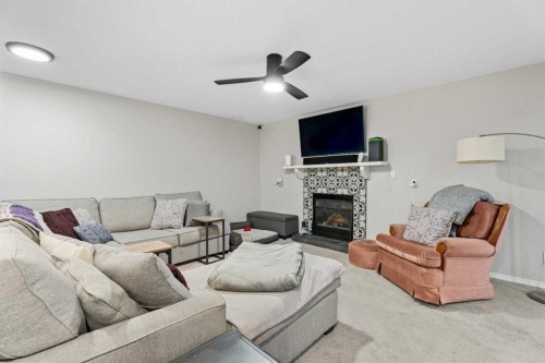 117 Rocky Ridge Landing Nw, Calgary, AB - Indoor Photo Showing Living Room With Fireplace