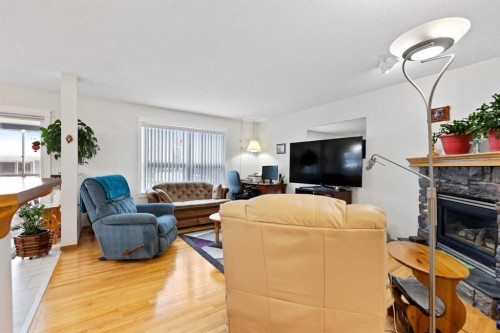 158 Somerglen Road Sw, Calgary, AB - Indoor Photo Showing Living Room With Fireplace
