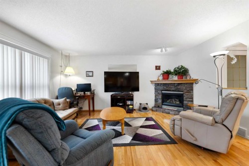158 Somerglen Road Sw, Calgary, AB - Indoor Photo Showing Living Room With Fireplace