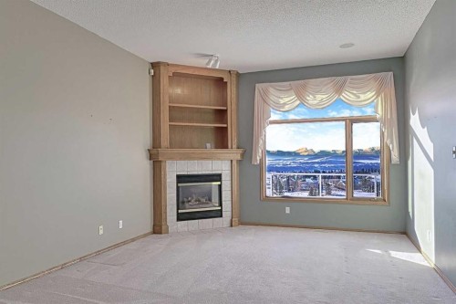 54 Eagleview Way, Cochrane, AB - Indoor Photo Showing Other Room With Fireplace