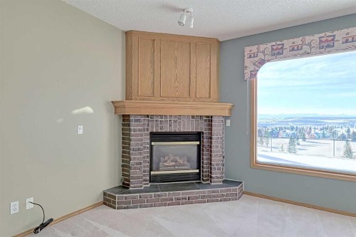 54 Eagleview Way, Cochrane, AB - Indoor Photo Showing Living Room With Fireplace